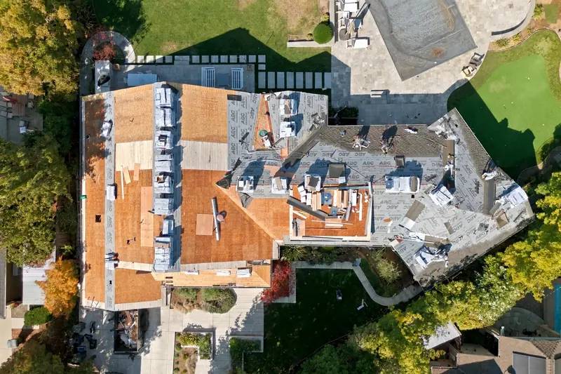 Aerial view of a roof replacement in progress in Los Altos, CA, with CertainTeed Presidential TL shingles going on