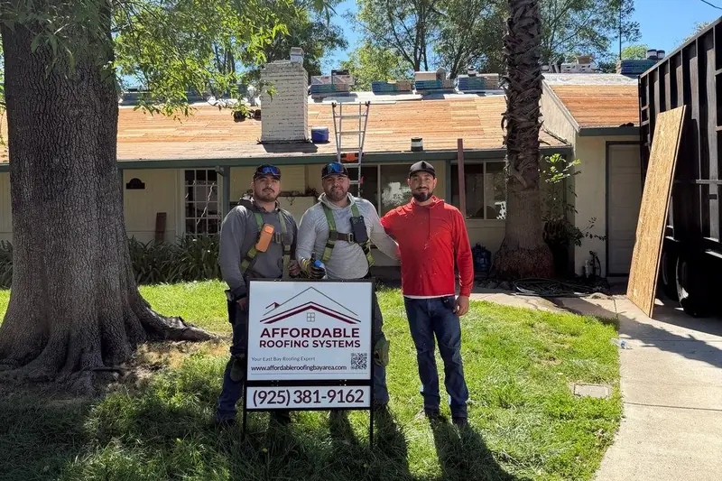 Ivan, Jesus and Brian of Affordable Roofing Systems behind the company yard sign at a job in Pleasant Hill, CA